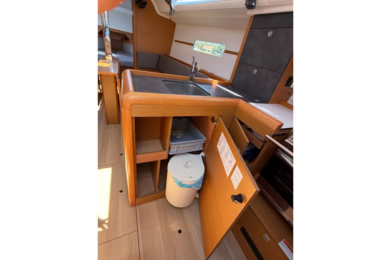 Slide: The Image of Interior of 2015 Jeanneau Sun Odyssey 349 sailboat, featuring a compact kitchen area. - 47