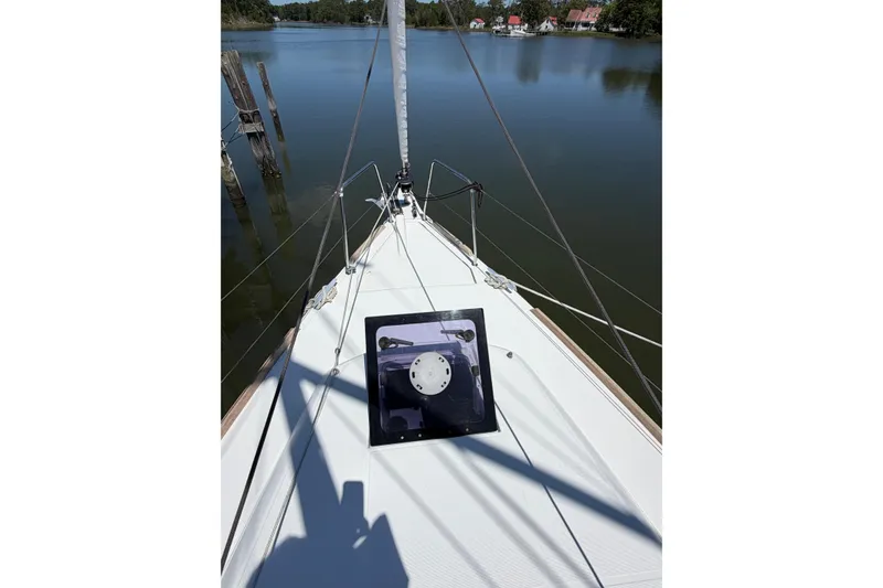 Slide: The Image of Bow view of 2015 Jeanneau Sun Odyssey 349 sailboat on calm water. - 9