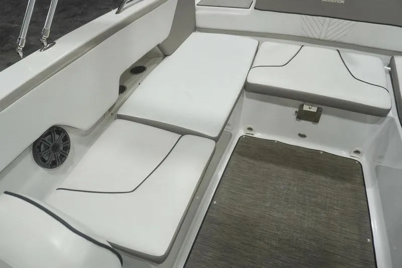 Slide: The Image of 2022 Glastron GTD 220 boat interior with white cushioned seating and speaker. - 12