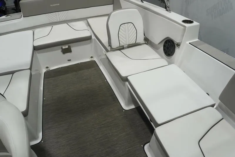 Slide: The Image of 2022 Glastron GTD 220 boat interior with white cushioned seating and gray flooring. - 13