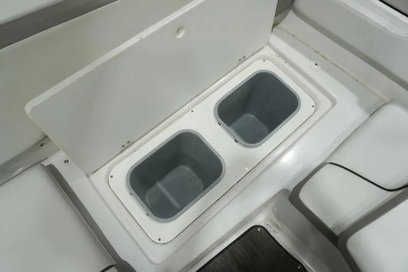 Slide: The Image of 2022 Glastron GTD 220 boat storage compartments with open lid, showcasing interior space. - 16