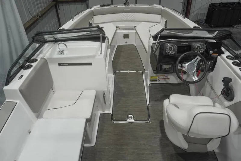 Slide: The Image of 2022 Glastron GTD 220 boat interior with steering wheel, seating, and dashboard. - 6