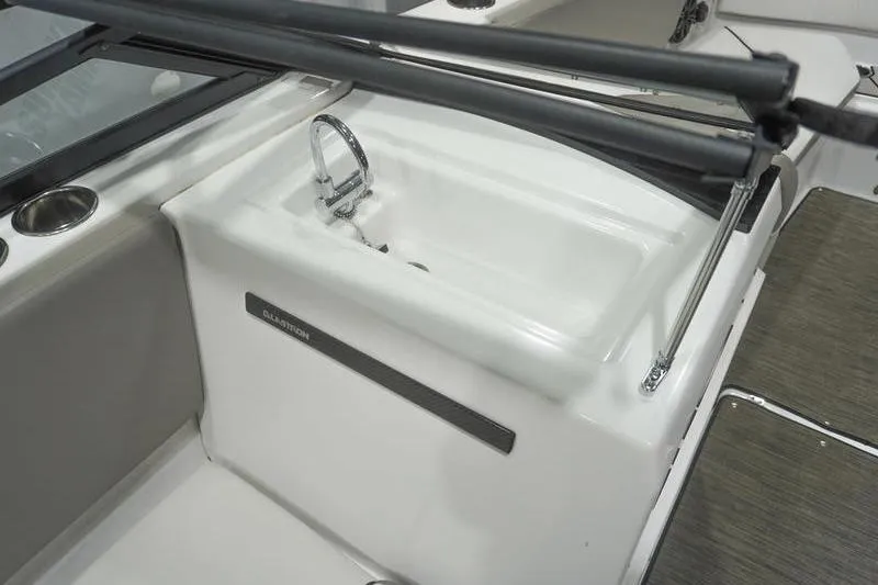 Slide: The Image of 2022 Glastron GTD 220 boat interior with sink and cup holder. - 8