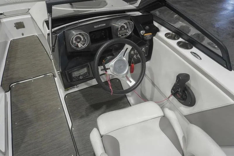 Slide: The Image of 2022 Glastron GTD 220 boat interior with steering wheel and dashboard controls. - 9