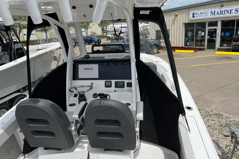 Slide: The Image of 2026 Sea Pro 245FLX Sandbar boat interior with dual seats and Simrad navigation system. - 10