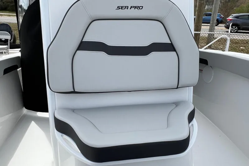 Slide: The Image of 2026 Sea Pro 245FLX Sandbar boat seat, featuring sleek white and black design. - 14