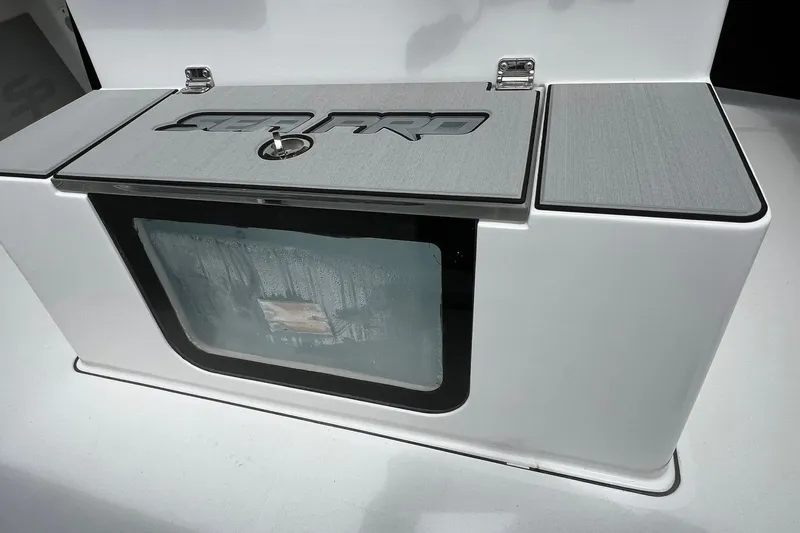 Slide: The Image of 2026 Sea Pro 245FLX Sandbar boat compartment with sleek design and secure latch. - 17