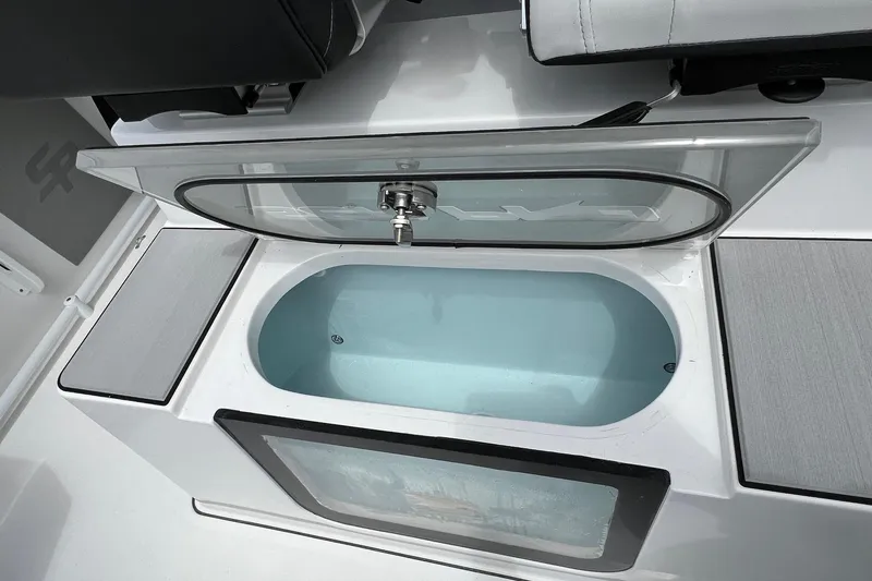 Slide: The Image of Open livewell on 2026 Sea Pro 245FLX Sandbar boat, showcasing interior design. - 18