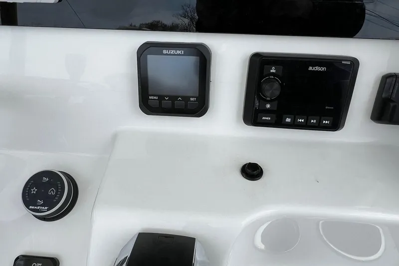 Slide: The Image of Control panel of 2026 Sea Pro 245FLX Sandbar boat with Suzuki and Audison displays. - 22