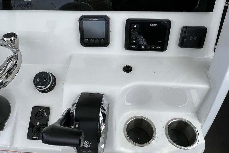 Slide: The Image of 2026 Sea Pro 245FLX Sandbar boat dashboard with controls and cup holders. - 23