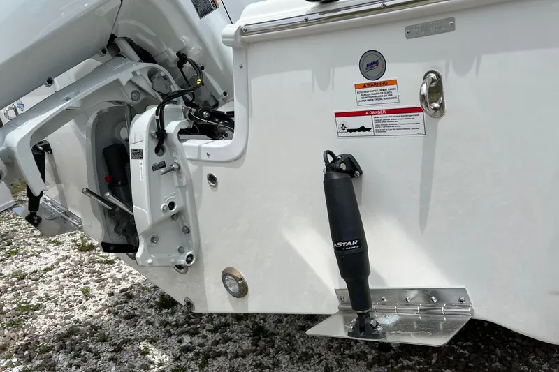 Slide: The Image of 2026 Sea Pro 245FLX Sandbar boat stern with motor and warning labels. - 29