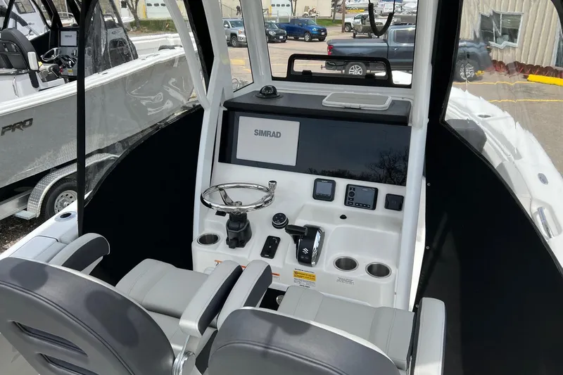 Slide: The Image of 2026 Sea Pro 245FLX Sandbar boat cockpit with steering wheel and navigation controls. - 8