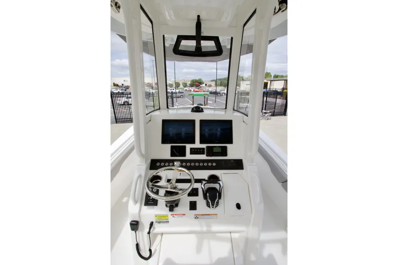Slide: The Image of 2027 Regulator 25 boat helm with modern controls and navigation screens. - 25