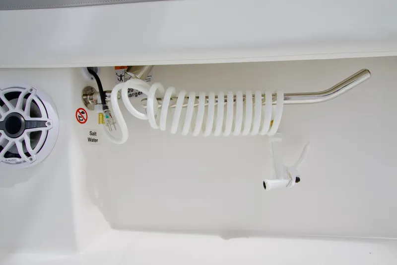 Slide: The Image of 2027 Regulator 25 boat detail with coiled hose and speaker in white interior. - 22