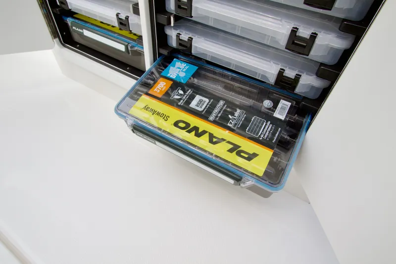 Slide: The Image of Storage compartment with Plano tackle boxes in a 2027 Regulator 25 boat. - 30