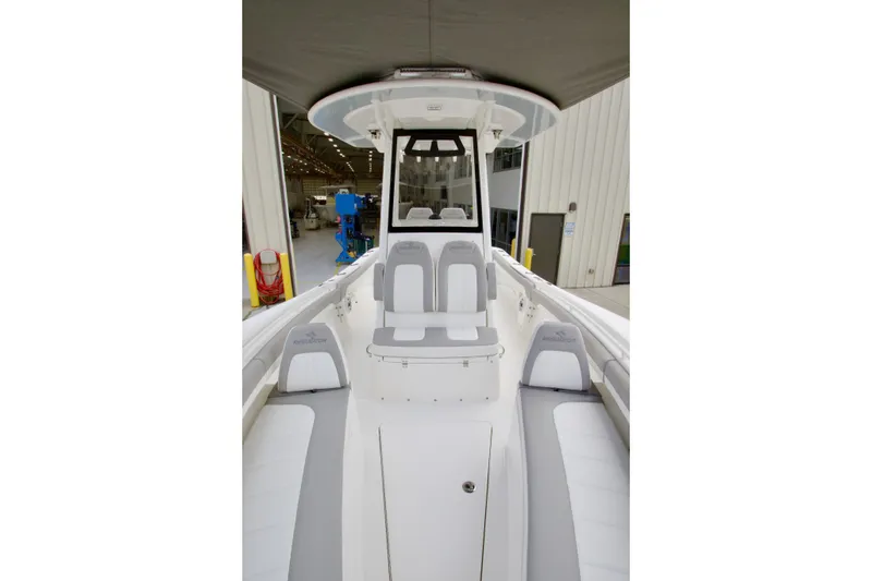 Slide: The Image of 2027 Regulator 25 boat interior with seating and console, in a showroom setting. - 15