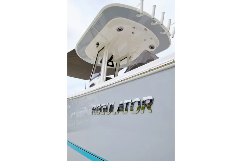Slide: The Image of 2027 Regulator 25 boat, side view with logo and T-top detail. - 6