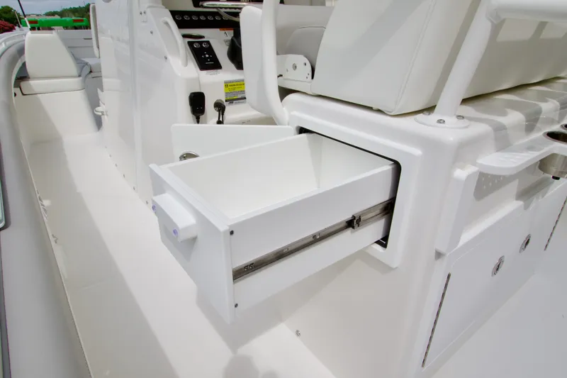 Slide: The Image of 2027 Regulator 25 boat interior with open storage drawer, showcasing sleek white design. - 28