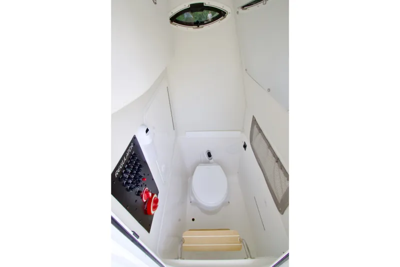 Slide: The Image of 2027 Regulator 25 boat interior with toilet and control panel. - 21