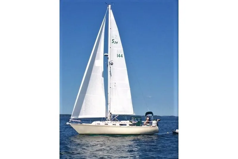 The Image of 1982 Sabre 34 sailboat on open water under clear blue sky. - 0