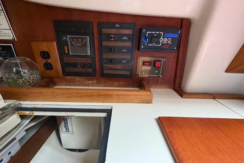 Slide: The Image of Control panel of a 1982 Sabre 34 sailboat with electrical switches and outlets. - 12