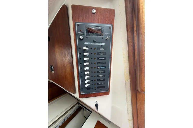 Slide: The Image of Electrical panel on a 1982 Sabre 34 sailboat, featuring switches and controls. - 16