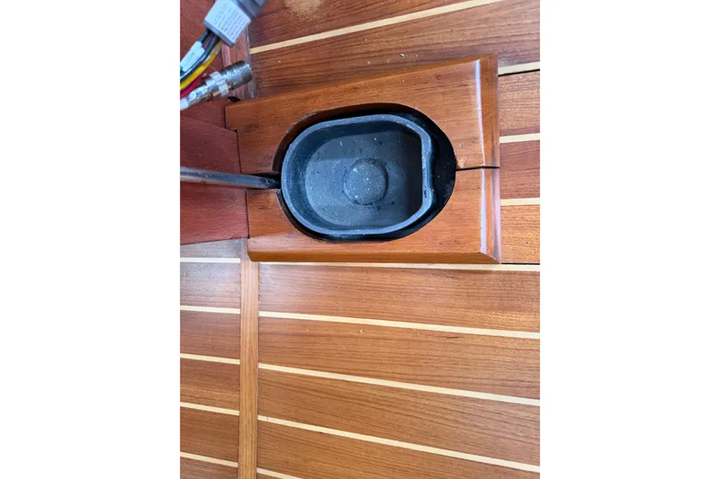 Slide: The Image of Wooden interior detail of a 1982 Sabre 34 sailboat, featuring a recessed black fitting. - 17