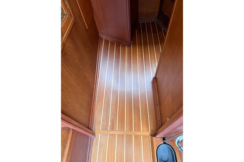 Slide: The Image of 1982 Sabre 34 interior with polished wooden flooring and cabinetry. - 19