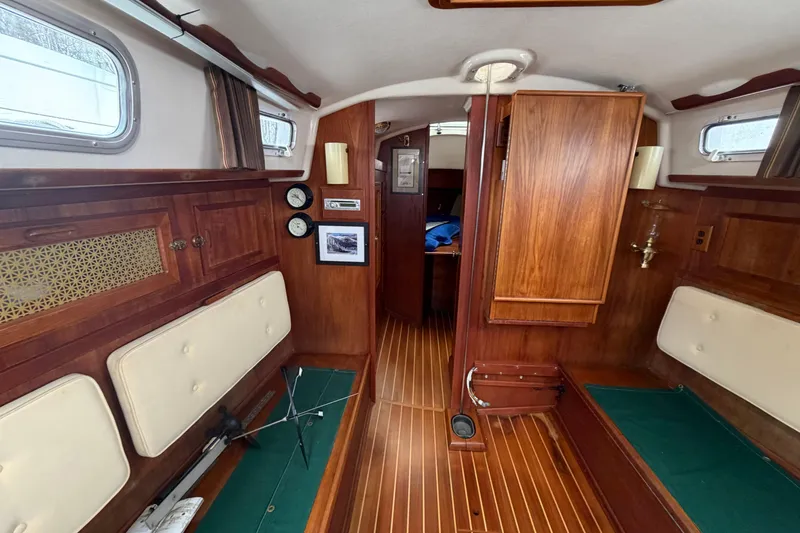 Slide: The Image of Interior of a 1982 Sabre 34 sailboat with wood paneling and seating. - 2