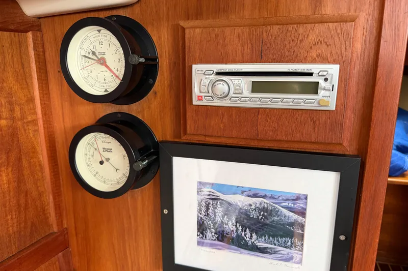 Slide: The Image of Interior of 1982 Sabre 34 yacht with gauges, CD player, and framed artwork. - 20