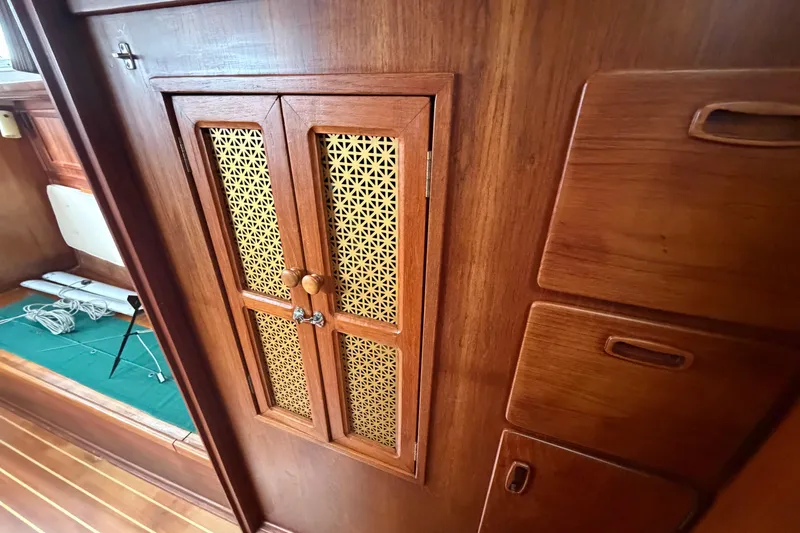 Slide: The Image of Wooden interior of 1982 Sabre 34 sailboat with decorative cabinet doors and storage compartments. - 25