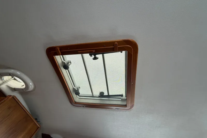 Slide: The Image of Interior view of a 1982 Sabre 34 sailboat hatch with wooden frame. - 27