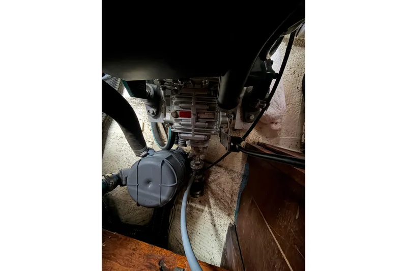 Slide: The Image of Engine compartment of a 1982 Sabre 34 sailboat, showcasing mechanical components and hoses. - 29