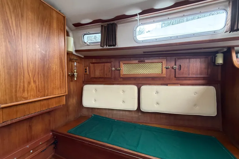 Slide: The Image of Interior of a 1982 Sabre 34 sailboat with wooden cabinetry and cushioned seating. - 3