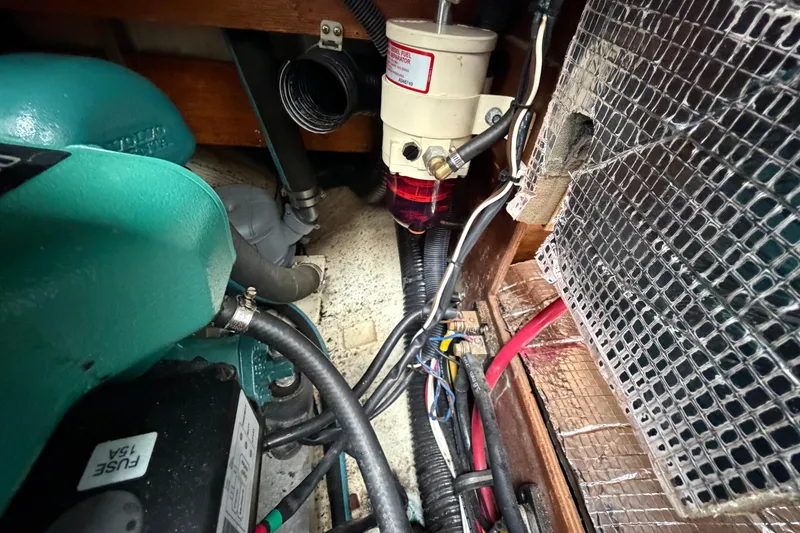 Slide: The Image of Engine compartment of a 1982 Sabre 34 sailboat, showing wiring and fuel filter system. - 33