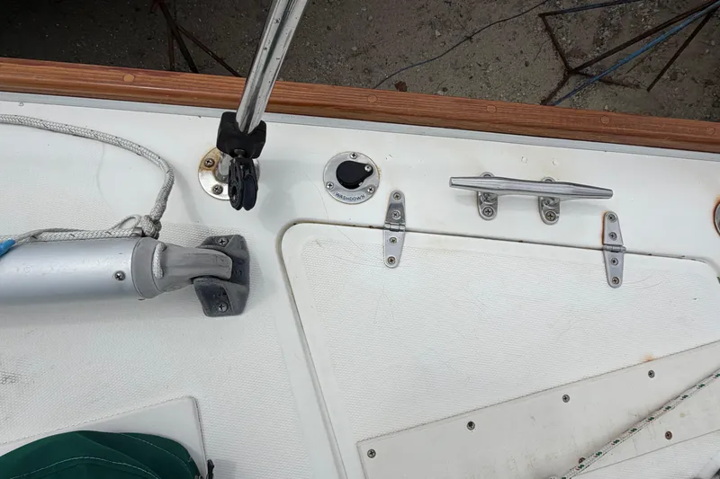 Slide: The Image of Deck fittings on a 1982 Sabre 34 sailboat, featuring cleats and rigging hardware. - 38