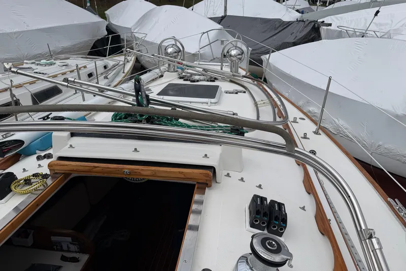 Slide: The Image of 1982 Sabre 34 sailboat deck with stainless steel fittings and covered boats in background. - 41