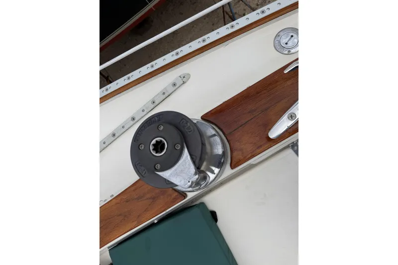 Slide: The Image of Deck detail of a 1982 Sabre 34 sailboat featuring a winch and wooden trim. - 42