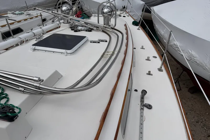 Slide: The Image of 1982 Sabre 34 sailboat deck with stainless steel fittings and wooden trim. - 46