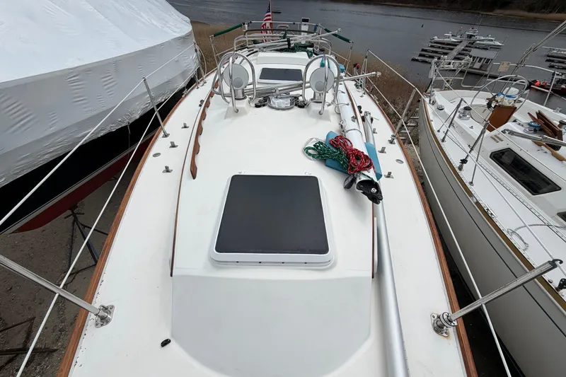 Slide: The Image of 1982 Sabre 34 sailboat deck with ropes, docked near water. - 47