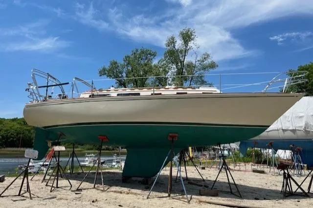 Slide: The Image of 1982 Sabre 34 sailboat on stands, displayed outdoors under a clear blue sky. - 52