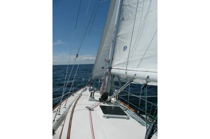 Slide: The Image of 1982 Sabre 34 sailboat on open sea with clear blue sky. - 53