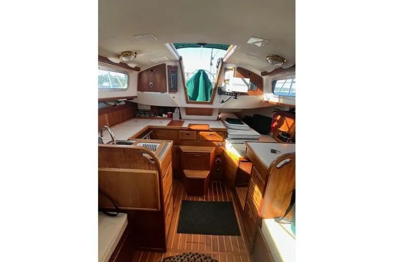 Slide: The Image of Interior of a 1982 Sabre 34 sailboat, featuring wooden cabinetry and compact design. - 6