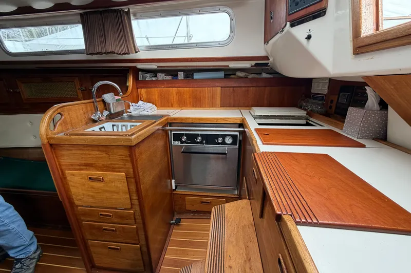 Slide: The Image of Interior of 1982 Sabre 34 sailboat galley with wood cabinetry and stainless steel appliances. - 8