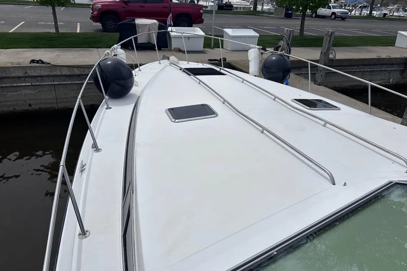 Slide: The Image of 1989 Sea Ray 390 Express Cruiser docked, showing deck and railings. - 10