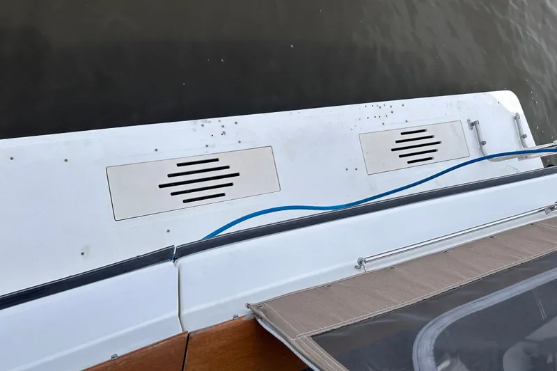 Slide: The Image of 1989 Sea Ray 390 Express Cruiser deck with vents and blue cable. - 13