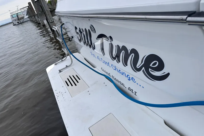 Slide: The Image of 1989 Sea Ray 390 Express Cruiser docked, featuring "Still Time" name on hull. - 15