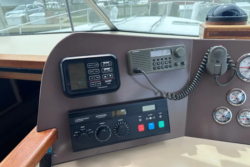 Slide: The Image of Control panel of a 1989 Sea Ray 390 Express Cruiser with navigation and communication equipment. - 19