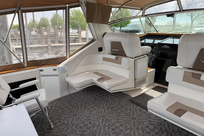 Slide: The Image of 1989 Sea Ray 390 Express Cruiser interior with white seating and patterned carpet. - 28