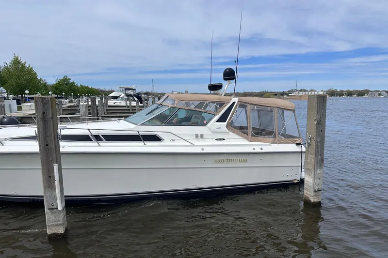 Slide: The Image of 1989 Sea Ray 390 Express Cruiser docked at a marina on a clear day. - 3